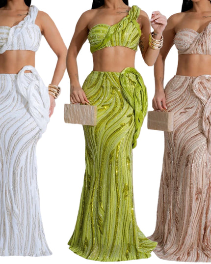 Three women wearing elegant dresses in white, green, and beige.
