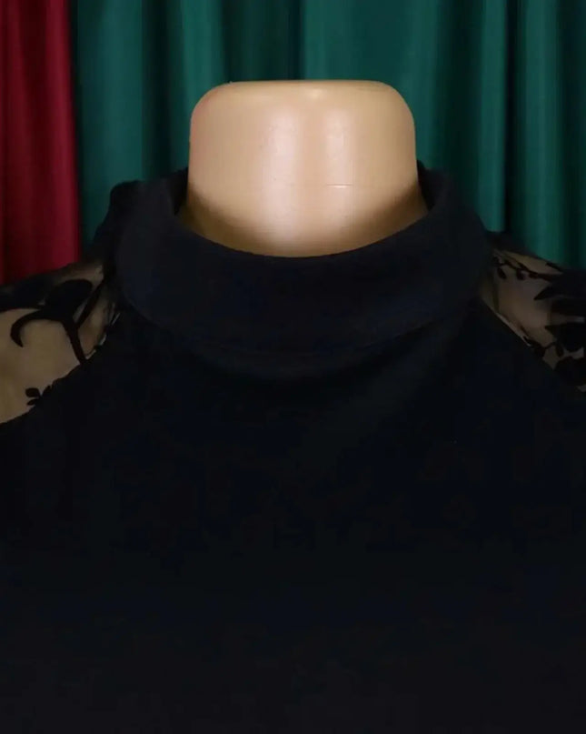 Black turtleneck sweater on a mannequin with a plain background