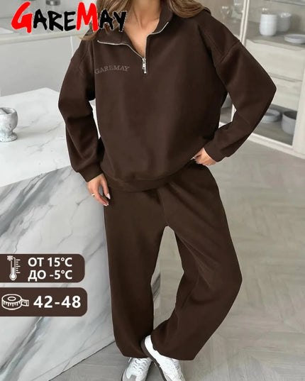 Person wearing a brown tracksuit with 'GAREMAY' branding in a room.