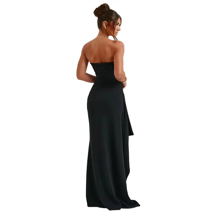Woman wearing a black strapless gown on a white background