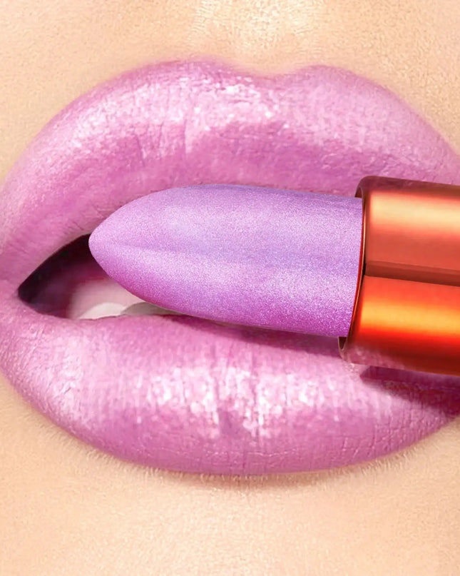 Purple lipstick being applied to a lip with a beige background