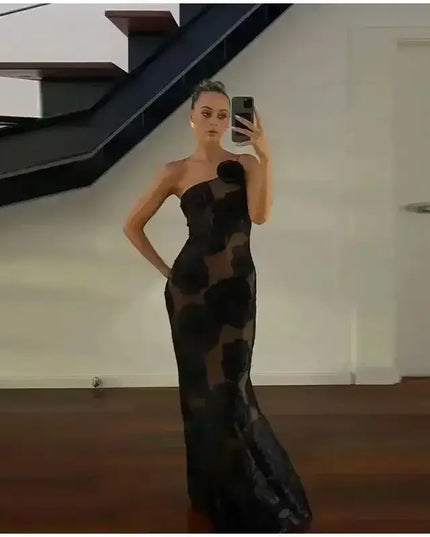 Oligai one shoulder elegant dress displayed by a model in a reflective setting, showcasing its sexy mesh bodycon design.