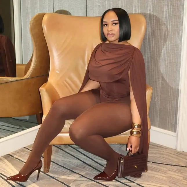 Woman in a brown outfit sitting on a leather chair in an indoor setting