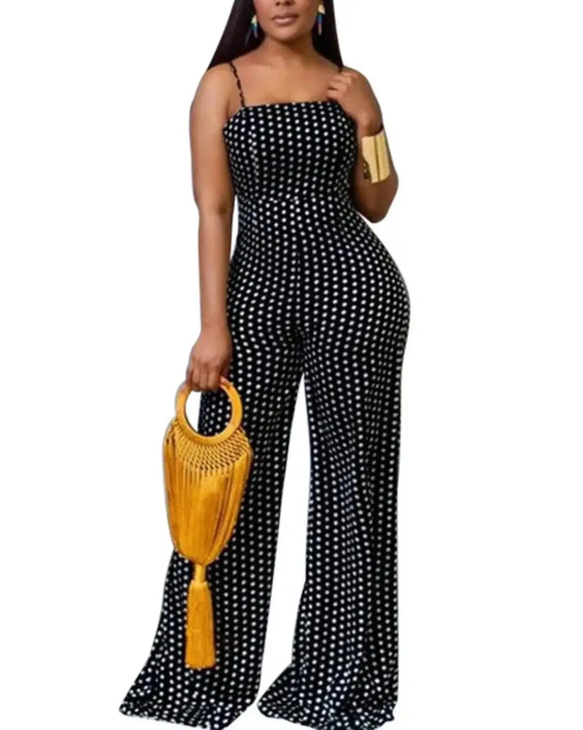Woman wearing a black polka dot jumpsuit holding a yellow handbag on a white background