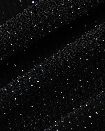 Black fabric with small white dots on a dark background