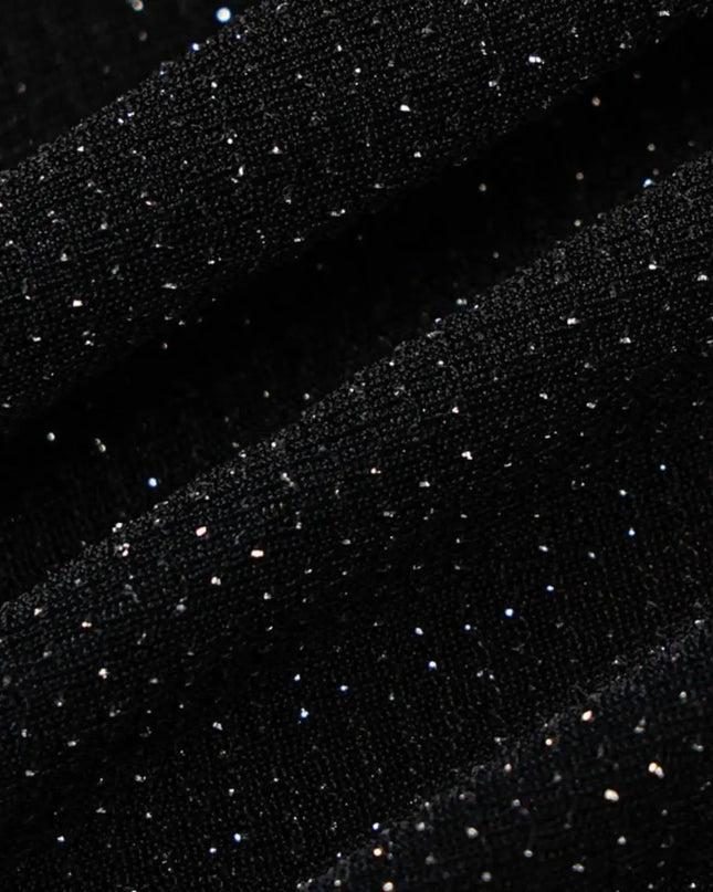 Black fabric with small white dots on a dark background