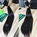 Two images of black hair extensions held by a person on a wooden surface with a green package.