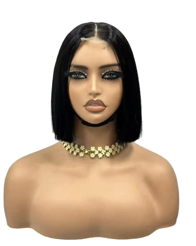 Mannequin head with a black bob wig and gold necklace on a white background