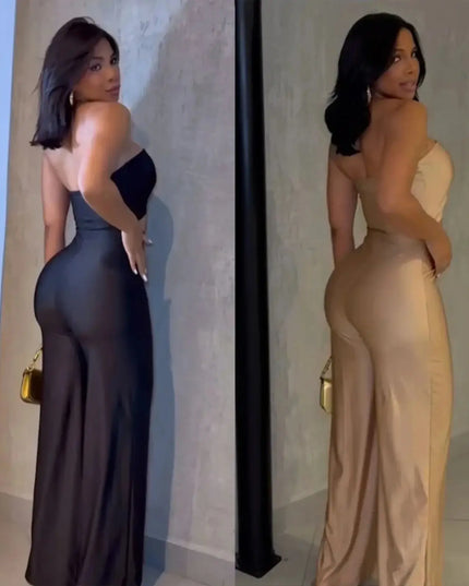 Two women in evening gowns standing against a neutral wall.