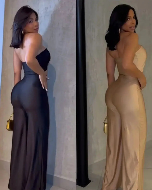 Two women in evening gowns standing against a neutral wall.