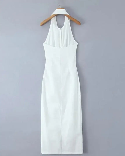 White cotton linen summer dress hanging on a hanger, featuring a backless halter design and a midi length.