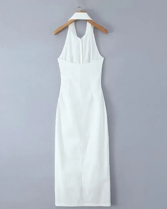 White cotton linen summer dress hanging on a hanger, featuring a backless halter design and a midi length.