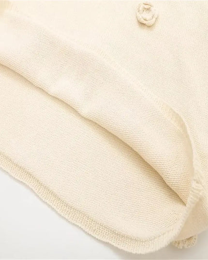 Detail of KADUWAKI gothic embroidered dresses for women showcasing soft knitted fabric and decorative button.