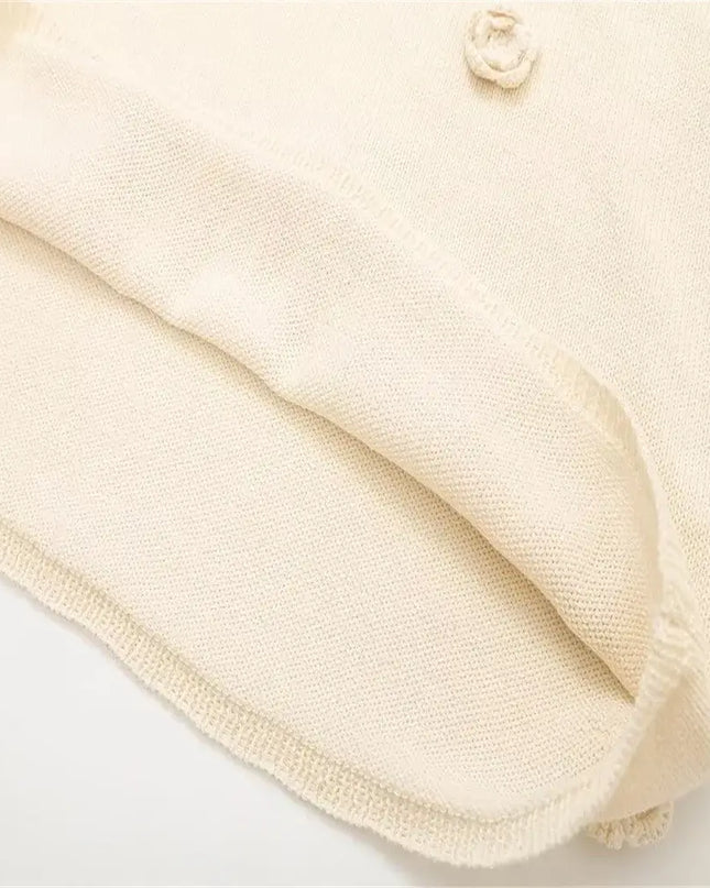 Detail of KADUWAKI gothic embroidered dresses for women showcasing soft knitted fabric and decorative button.