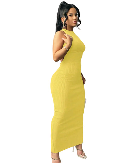 Woman wearing a yellow dress against a plain wall.