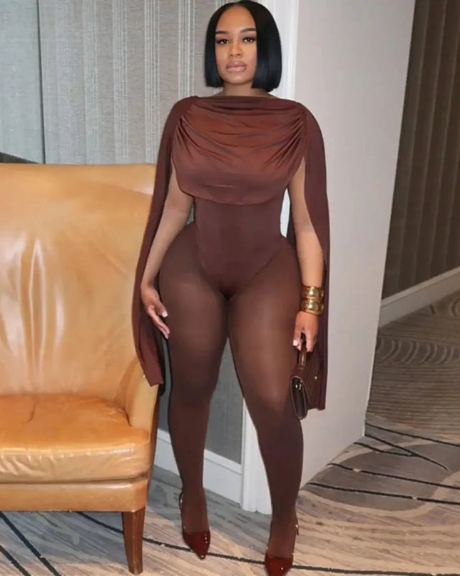 Woman in a brown outfit standing in a room with a beige sofa.