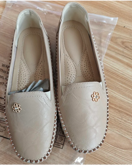 comfortable women's loafers with laser stitch detail in beige, flat slip-on shoes for casual streetwear.