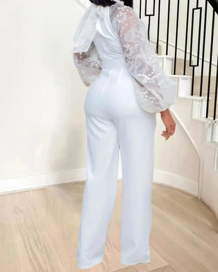 Person wearing a white outfit with lace sleeves in a home setting.