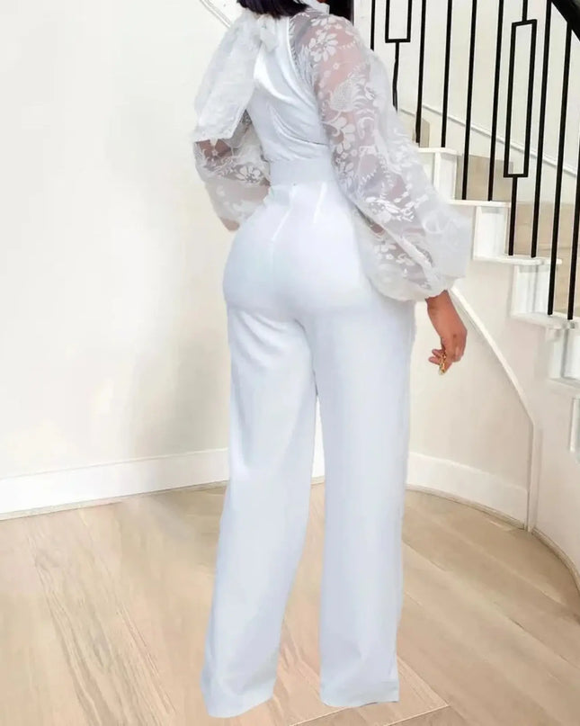 Person wearing a white outfit with lace sleeves in a home setting.
