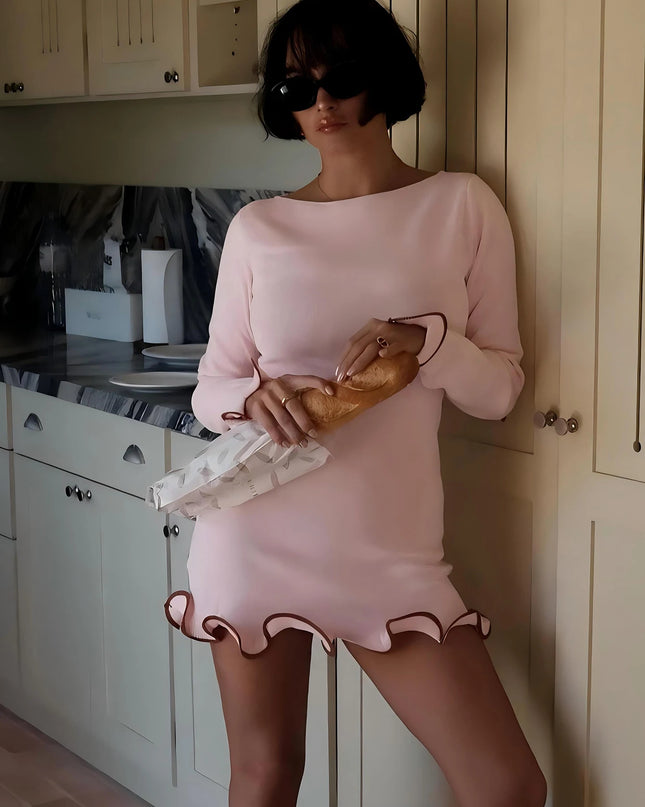 Women’s Ruffled Patchwork Bodycon Mini Dress – Long Sleeve in pink with ruffled hem, worn confidently in a kitchen setting.