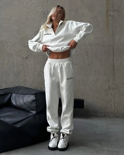 Person wearing a white outfit with 'Dior' branding in a minimalistic setting.