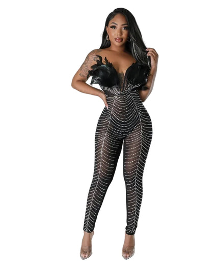 Model wearing a black and silver rhinestone jumpsuit on a gray background