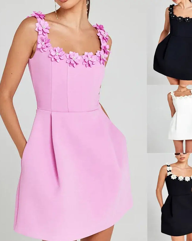 Pink dress with floral straps on a gray background