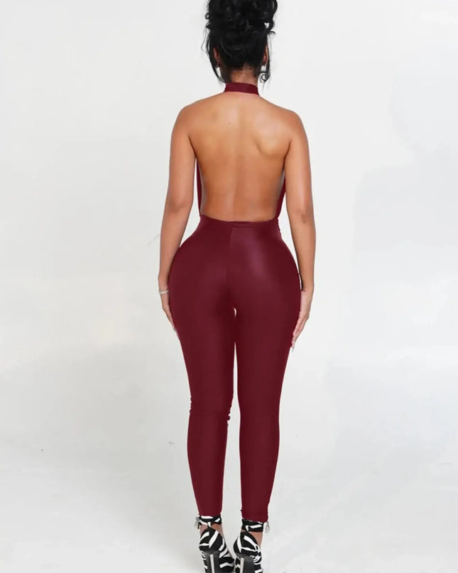 Person wearing a burgundy open-back jumpsuit on a white background