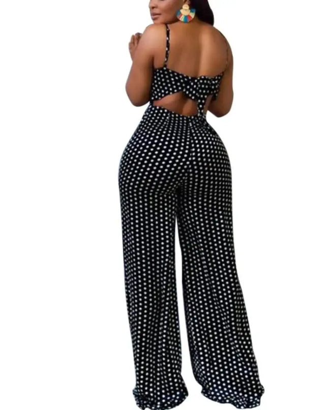 Black and white polka dot jumpsuit with cut-out design on a white background