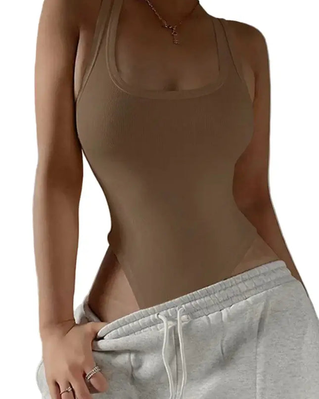 Person wearing a beige tank top and gray sweatpants against a neutral background