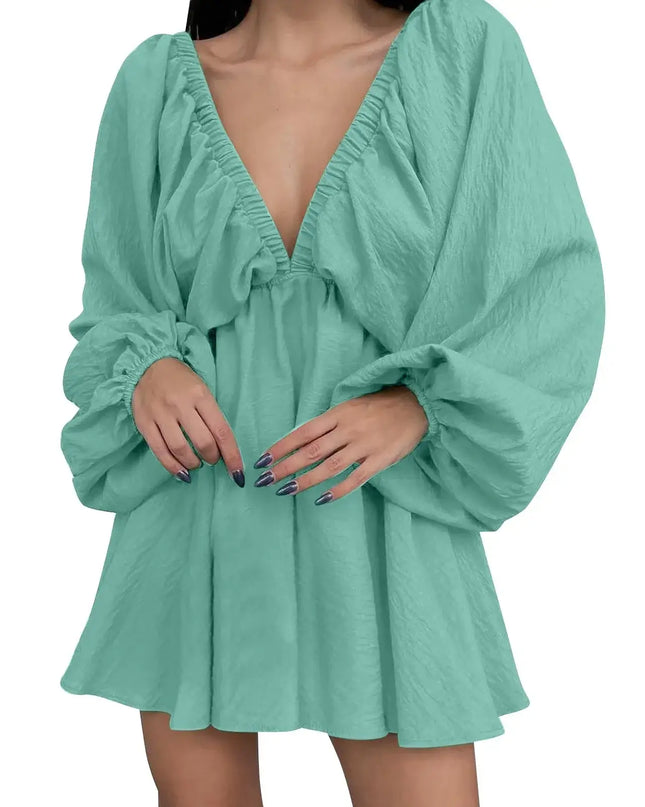 Mint green dress with long sleeves on a white background