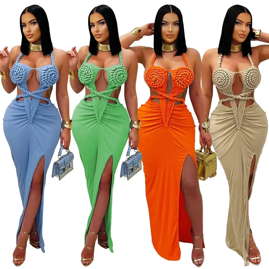 Four women wearing colorful, intricately designed dresses with matching handbags.