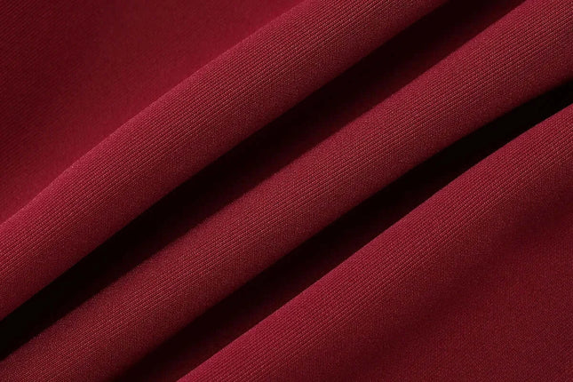 close-up of luxurious burgundy fabric showcasing smooth, elegant texture for off shoulder mini dress party.