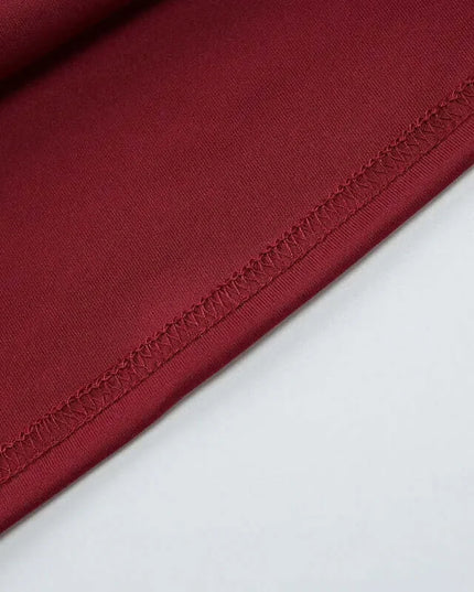 Close-up view of luxurious burgundy fabric showcasing the fine stitching, perfect for elegant off shoulder mini dress party attire.