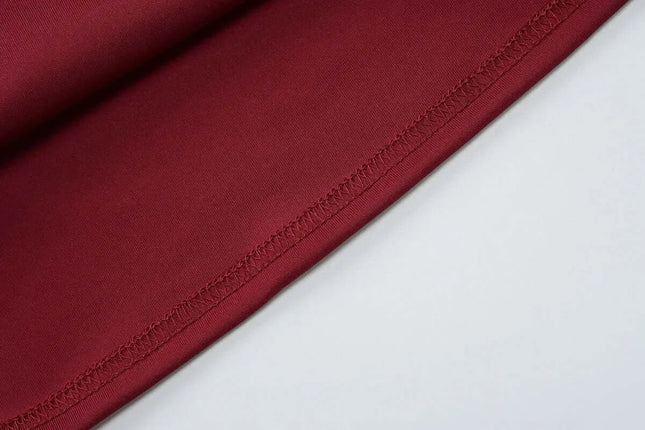 Close-up view of luxurious burgundy fabric showcasing the fine stitching, perfect for elegant off shoulder mini dress party attire.