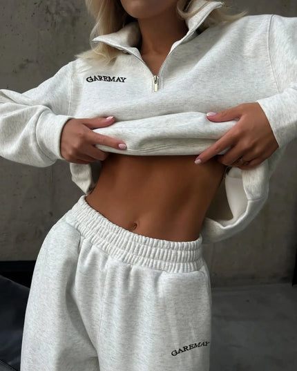 Person wearing a gray 'GAPMEAY' tracksuit against a neutral background