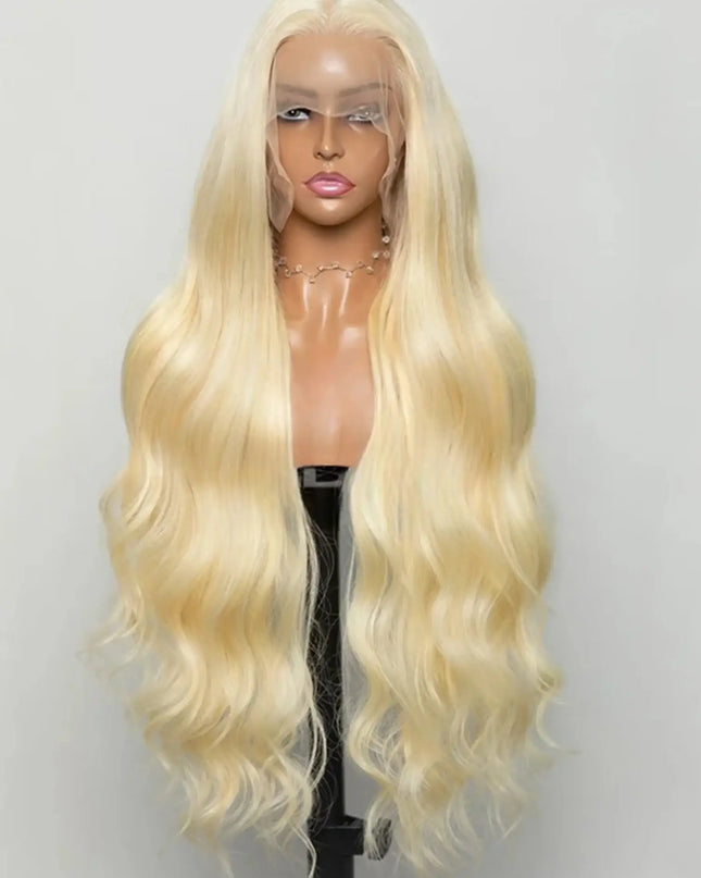 Blonde wig on a mannequin head against a plain background