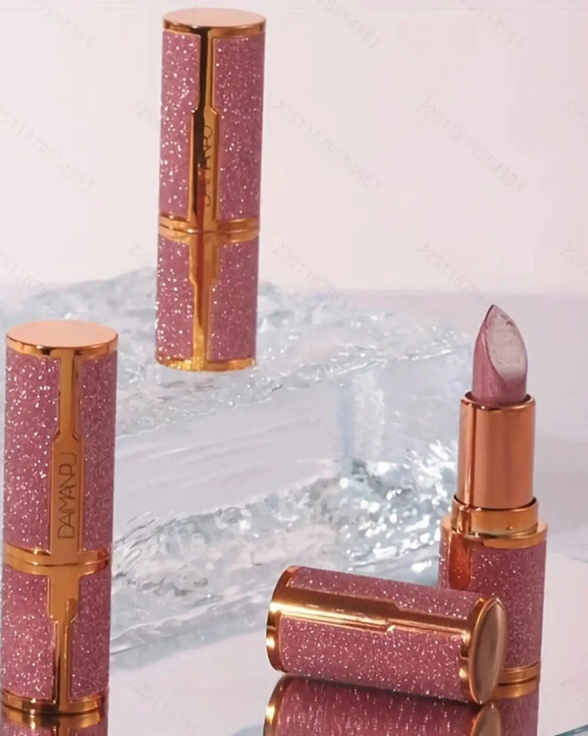 Pink glittery lipsticks with gold accents on a reflective surface
