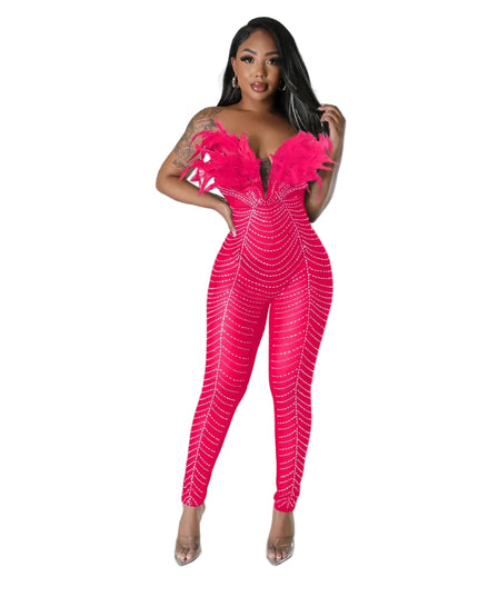 Woman wearing a bright pink jumpsuit with a textured pattern on a gray background