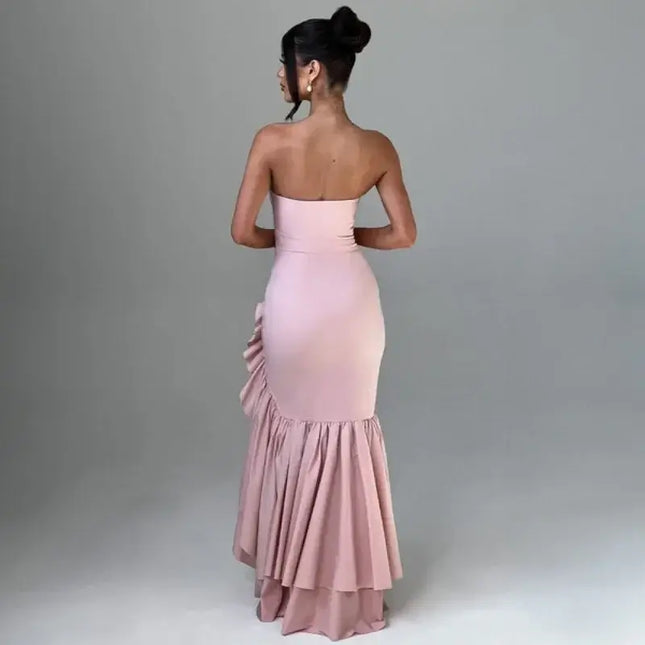 Sexy strapless summer dress showcased from the back, highlighting its elegant design and ruffled hem in a soft pink color.
