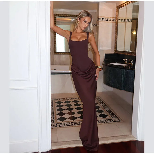 Brown pleated maxi dress showcasing a stylish woman in a luxurious bathroom setting.