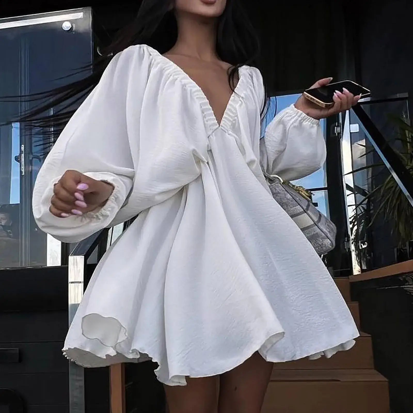 Deep V-neck pleated white dress with long sleeves, showcasing a sexy retro style.