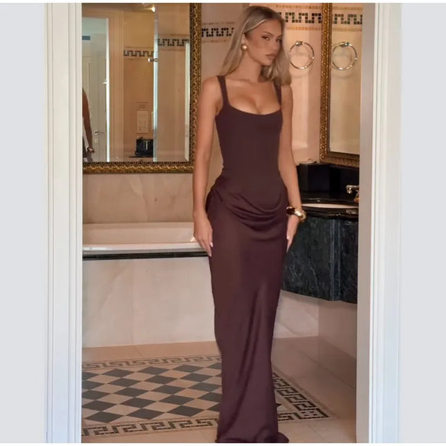 Brown pleated maxi dress worn by a model, showcasing its elegant square neck and sleeveless design.