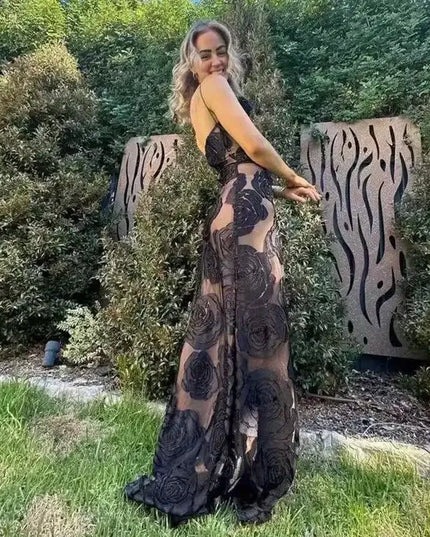 Oligai one shoulder elegant dress in black mesh design worn outdoors, showcasing its sexy bodycon fit and floral details.