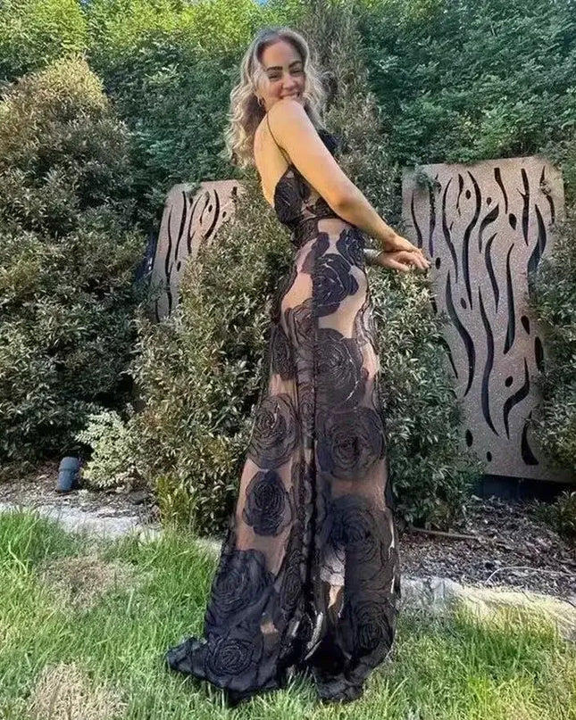 Oligai one shoulder elegant dress in black mesh design worn outdoors, showcasing its sexy bodycon fit and floral details.