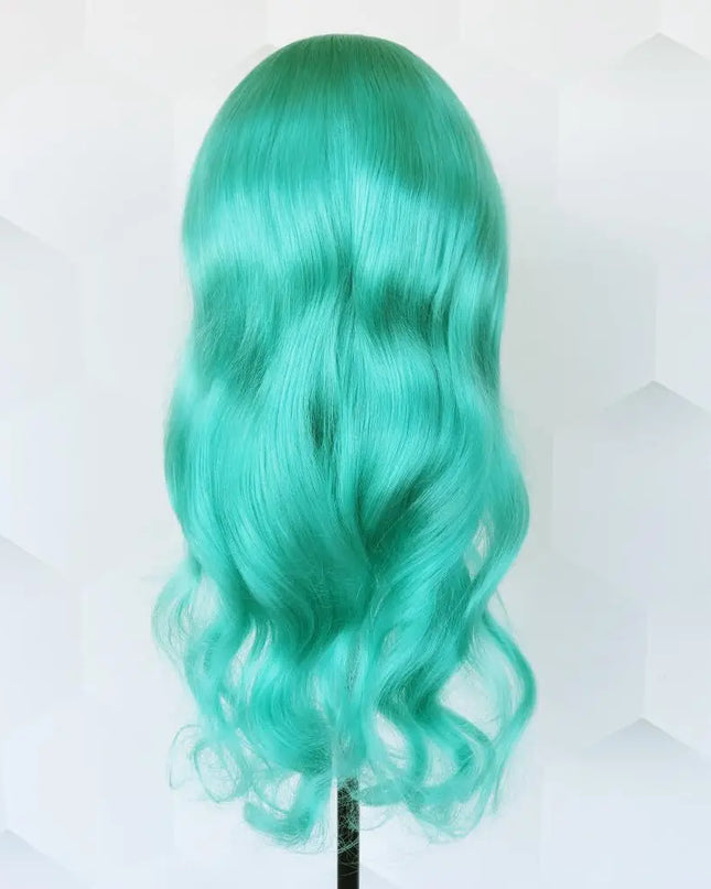 Teal wig on a mannequin head against a light background