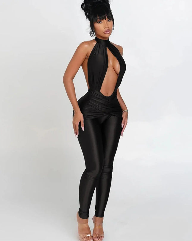 Woman wearing a black leather jumpsuit on a white background