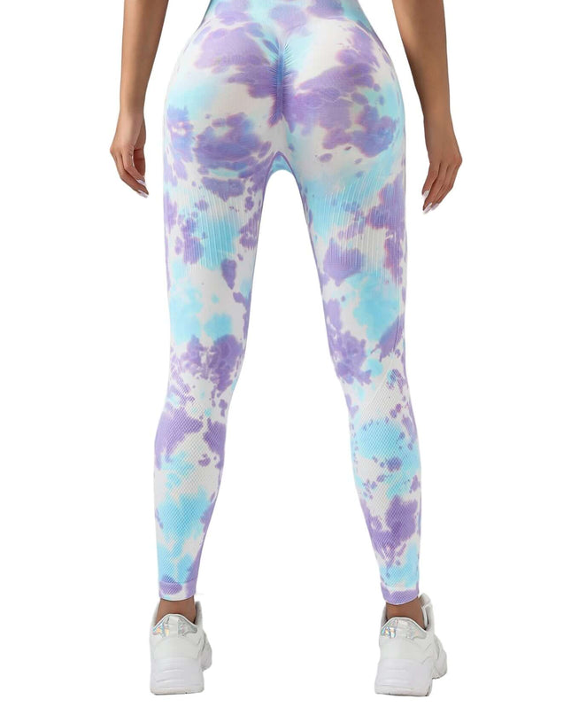 Multicolored tie-dye leggings worn by a person on a gray background
