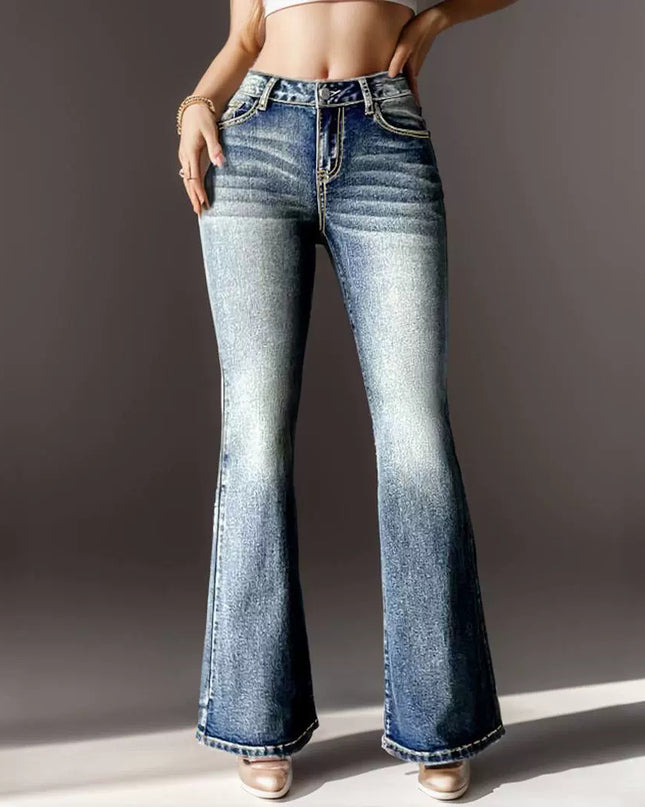 Flared jeans worn by a person on a plain background