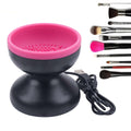 Black and pink makeup brush holder with USB cable and makeup brushes on a white background